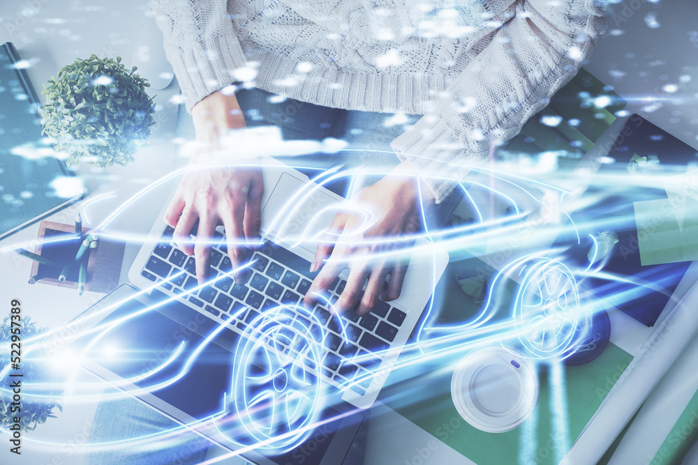 Poster double exposure of woman hands working on computer and car hologram drawing. top view. auto pilot co