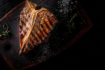 Grilled T-bone Steak on bones on wooden board