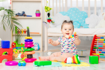 happy baby playing at home or in kindergarten. Toys for small children. early development