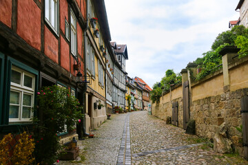 Fototapeta na wymiar Narrow lane in Quedlinburg, Germany with Half-Timbered Houses
