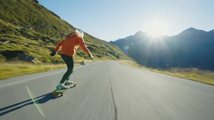 Foto op Plexiglas Cinematic downhill longboard session. Young woman skateboarding and making tricks between the curves on a mountain pass. Concept about extreme sports and people © oneinchpunch