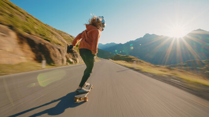 Fototapeta Cinematic downhill longboard session. Young woman skateboarding and making tricks between the curves on a mountain pass. Concept about extreme sports and people obraz