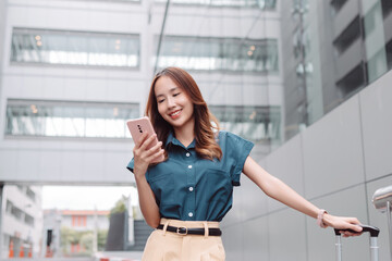 Beautiful asian female businesswoman use smartphone, Walk enjoy smiling while doing commuting in the modern city near office building outside