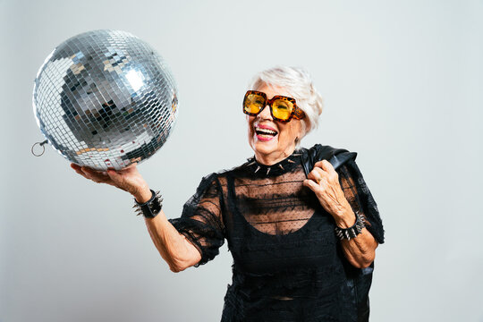image of a beautiful and elegant old influencer woman. Cool grandmother posing in studio wearing fashionable clothes
