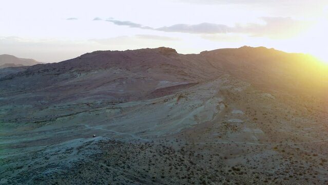 Aerial Slowly Panning A Sunset Across A Rugged Desert And Hilly Terrain -  Palm Springs, California