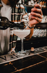 man bartender hand making cocktail in bar.