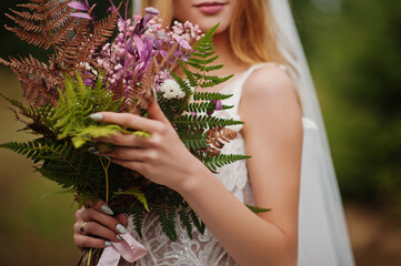 Bride holding beautiful tender wedding bouquet.