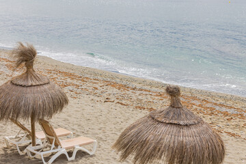 A beach with natural fiber umbrellas to protect you from the sun