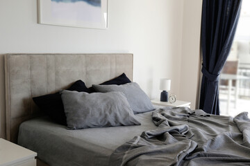 Room with an empty king sized bed with headboard, perfectly clean and ironed sheets, puffy pillows...