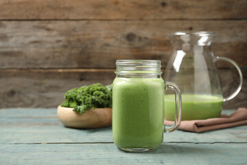 Tasty fresh kale smoothie on light blue wooden table