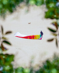 man packing up paragliding 