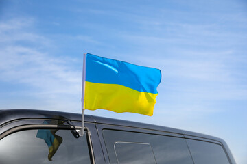National flag of Ukraine on car window outdoors