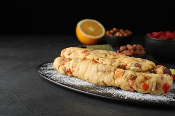 Unbaked Stollen with candied fruits and raisins on grey table. Space for text