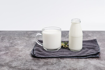 beverage liquid milk white fresh natural in glass bottles on table drink to healthy has protein and calcium for child or toddler, nobody, closeup, white background and copy space on left for content