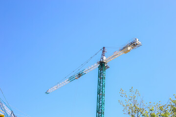 Building site background. Construction site with crane and building. Construction crane. Empty Space for text. Construction concept. Site. New buildings with a crane. Tower crane