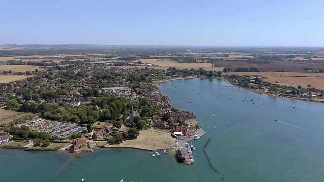 Aerial over the beautiful village of Bosham, a popular sailing location in West Sussex England, the Saxon  Holy Trinity Church can be seen clearly.