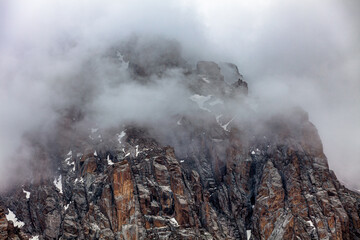 lonely brutal rock among the descending clouds. View from Chimbulak
