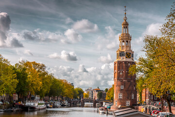 Fototapeta na wymiar The Montelbaanstoren tower on Oudeschans canal in Amsterdam, Netherlands
