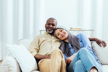 cinematic image of an happy multiethnic senior couple. Indoors Lifestyle moments at home. Concept...