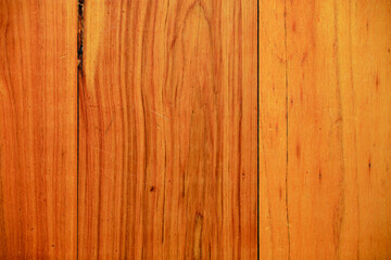 Closeup of some old hardwood floorboards (built in the 1970s), photographed from above showing...