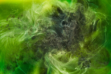 Liquid fluid art abstract background. Green dancing acrylic paints underwater, cosmic smoke ocean