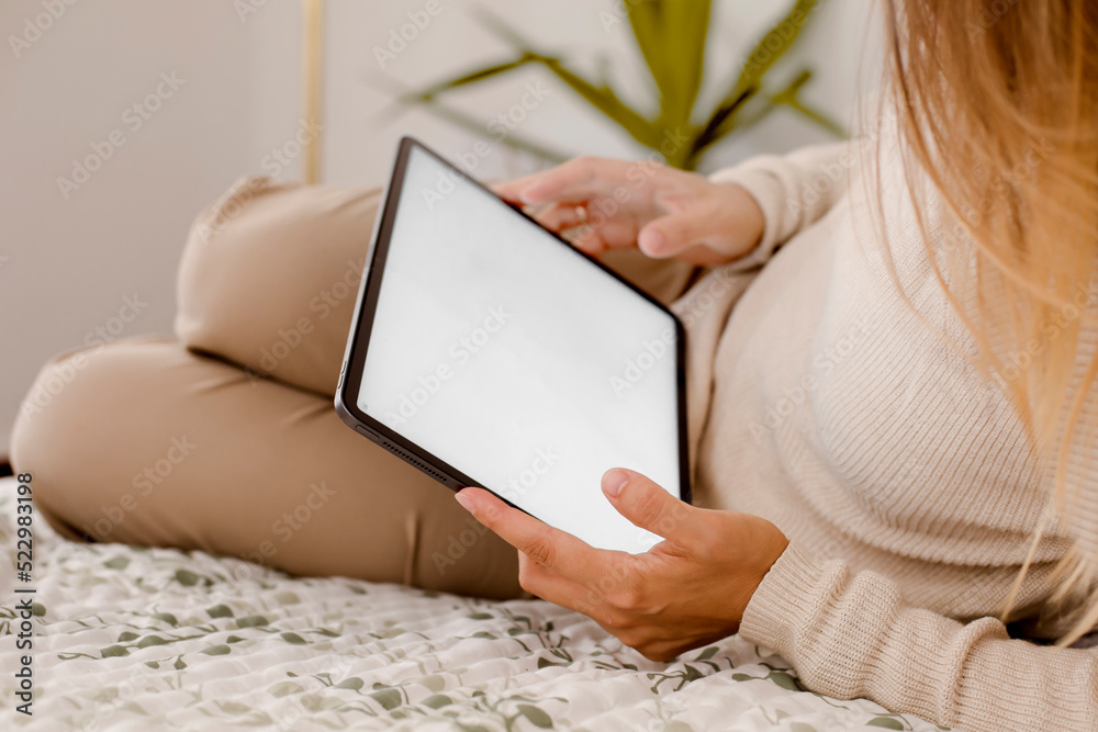 Wall mural casual woman hold tablet with white screen background at home