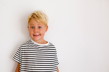 blondie cheerful 6 years old boy over white background