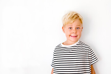 blondie cheerful 6 years old boy over white background - obrazy, fototapety, plakaty