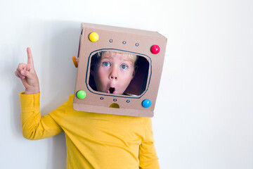 Caucasian Blondie boy over white background/boy in robot, astronaut creative costume