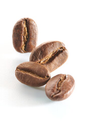 Roasted coffee beans isolated close up on white background, clipping path