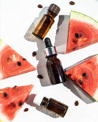 A bottle of watermelon seed oil. Packaging of natural essential oil or serum for the face with...