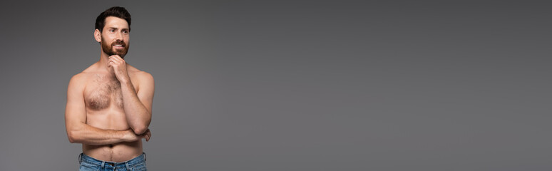 Fototapeta premium shirtless and bearded man with hair on chest smiling isolated on grey, banner.