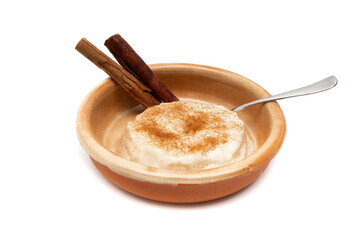Delicious rice pudding with cinnamon isolated on white. Rice pudding is a typical dessert of the gastronomy of many countries made by slowly cooking rice with milk and sugar.