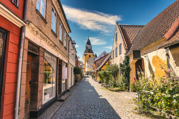 Fototapeta na wymiar Bell Tower and the old narrow streets in faaborg city, Denmark