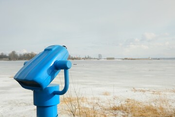 touristic telescope look at the city with view winter landscape , closeup binocular on background...