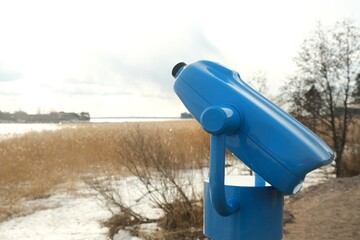 touristic telescope look at the city with view winter landscape , closeup binocular on background...