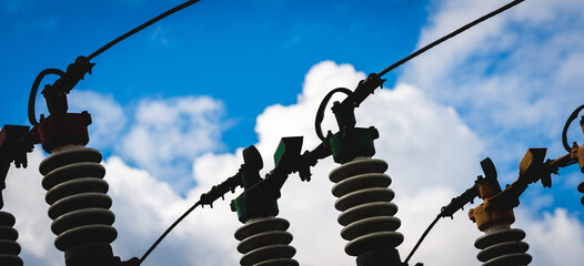 Silhouette Electric power transmission lines.High voltage switchgear and equipment of power...