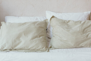 A bed with pillows. Bed linen made of natural fabrics.
