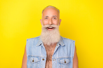 Photo of cheerful excited man pensioner dressed denim vest smiling open mouth isolated yellow color...