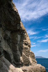 Scenic landscape of blue sea, cloudy sky. Huge rocks and stones on beach. Beautiful nature. The Golitsyn Trail.