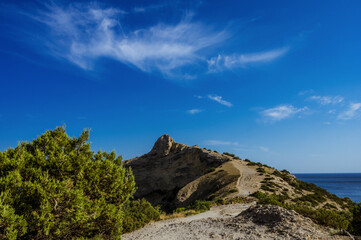 The trail on the cliff. Black sea. Blue sky. Nature of Crimea.