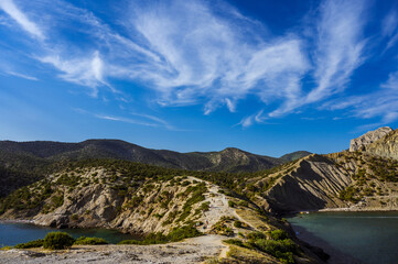 The trail on the cliff. Black sea. Blue sky. Nature of Crimea. Juniper grove. Novy Svet.