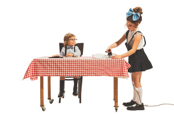 Cute two little kids, boy and girl in retro american style outfits like family couple isolated on white background. Comparison concept