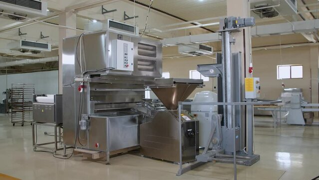 Big dough machine for mixing, cutting and rolling dough in the middle of bakery