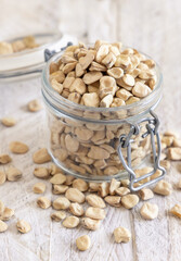 Glass jar of raw dry Grass pea on wooden table close up. Italian legumes Cicerchia