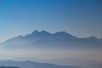 Silhouette of High Tatras Mountains at sunrise at clear blue sky background