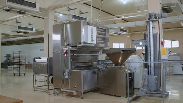 Big dough machine for mixing, cutting and rolling dough in the middle of bakery
