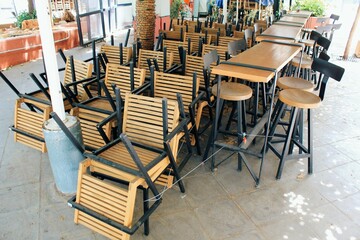 Tables and chairs stacked outside closed cafe-restaurant during the Coronavirus lockdown - Athens, Greece, May 6 2020.