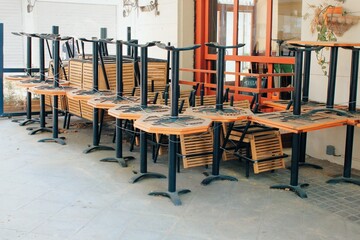Tables and chairs stacked outside closed cafe-restaurant during the Coronavirus lockdown - Athens, Greece, May 6 2020.