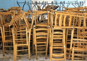 Tables and chairs stacked outside closed cafe-restaurant during the Coronavirus lockdown - Athens, Greece, May 6 2020.